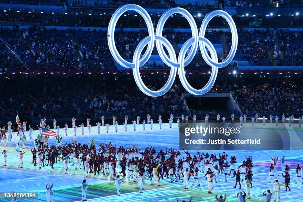 Flag bearers Brittany Bowe and John Shuster of Team United States carry their flag during the Opening Ceremony of the Beijing 2022 Winter Olympics at...