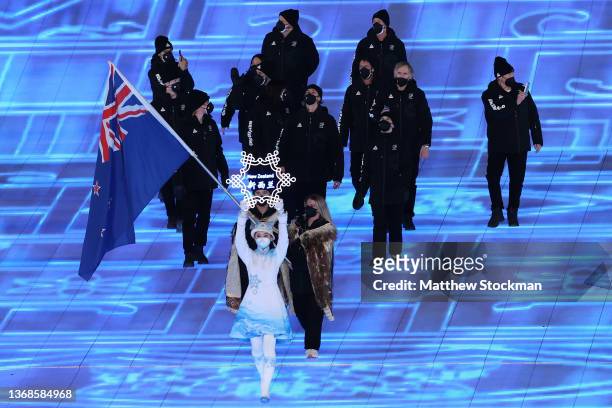 Flag bearers Finn Bilous and Alice Robinson of Team New Zealand carry their flag during the Opening Ceremony of the Beijing 2022 Winter Olympics at...