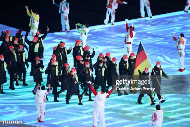 Flag bearers Francesco Friedrich and Claudia Pechstein of Team Germany carry their flag during the Opening Ceremony of the Beijing 2022 Winter...