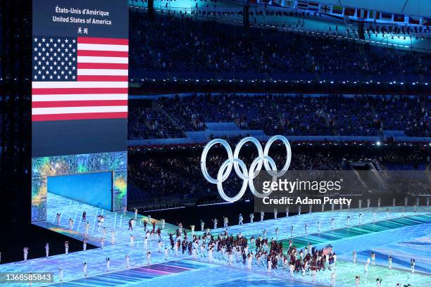 Flag bearers Brittany Bowe and John Shuster of Team United States carry their flag during the Opening Ceremony of the Beijing 2022 Winter Olympics at...