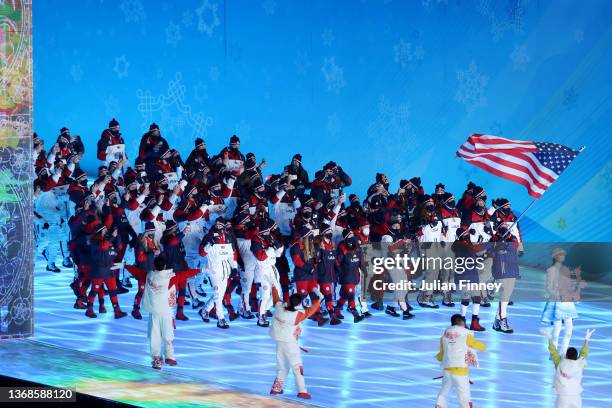 Flag bearers Brittany Bowe and John Shuster of Team United States carry their flag during the Opening Ceremony of the Beijing 2022 Winter Olympics at...