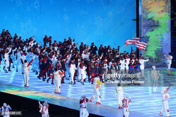 Flag bearers Brittany Bowe and John Shuster of Team United States carry their flag during the Opening Ceremony of the Beijing 2022 Winter Olympics at...