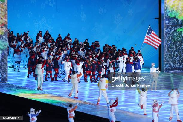 Flag bearers Brittany Bowe and John Shuster of Team United States carry their flag during the Opening Ceremony of the Beijing 2022 Winter Olympics at...