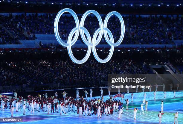 Flag bearers Brittany Bowe and John Shuster of Team United States carry their flag during the Opening Ceremony of the Beijing 2022 Winter Olympics at...