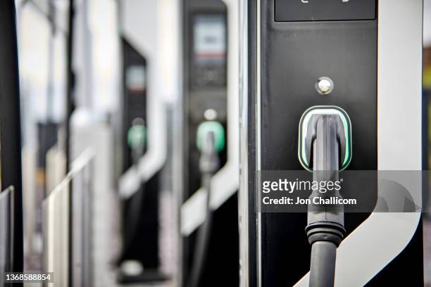 a bank of electric car chargers - hybrid car charging stock pictures, royalty-free photos & images