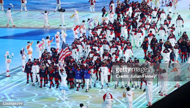 Flag bearers Brittany Bowe and John Shuster of Team United States carry their flag during the Opening Ceremony of the Beijing 2022 Winter Olympics at...