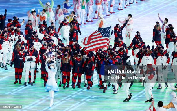 Flag bearers Brittany Bowe and John Shuster of Team United States carry their flag during the Opening Ceremony of the Beijing 2022 Winter Olympics at...