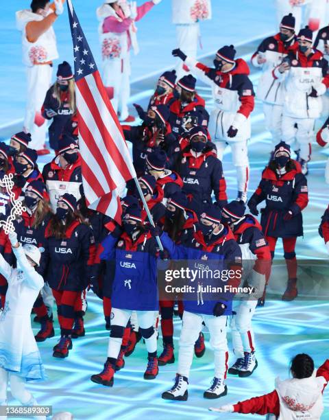 Flag bearers Brittany Bowe and John Shuster of Team United States carry their flag during the Opening Ceremony of the Beijing 2022 Winter Olympics at...