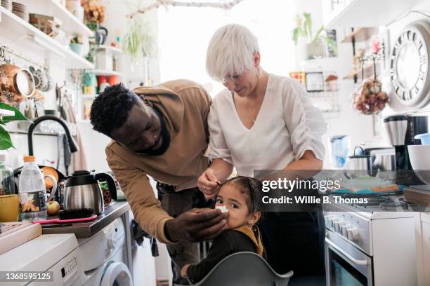 dad wiping daughters face while getting ready in kitchen - facial tissue stock pictures, royalty-free photos & images