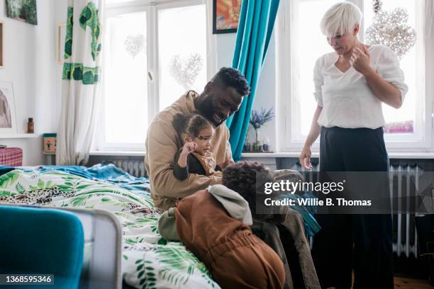 family getting ready to go out together - mother and daughter making the bed stock pictures, royalty-free photos & images
