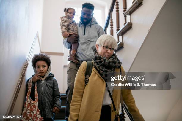 mixed race family leaving house together - leaving apartment stock pictures, royalty-free photos & images