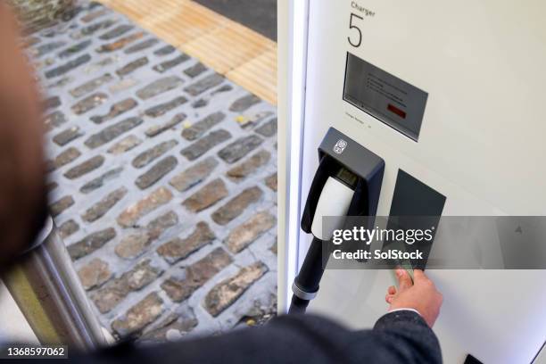 paying to charge my car - auto buy credit stock pictures, royalty-free photos & images