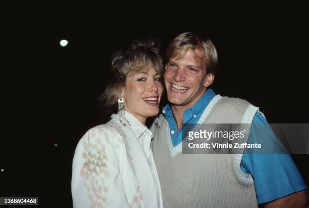 American actress Lydia Cornell, wearing a white jacket with grey and peach detail on the shoulder, and American swimmer Steve Lundquist, wearing a...