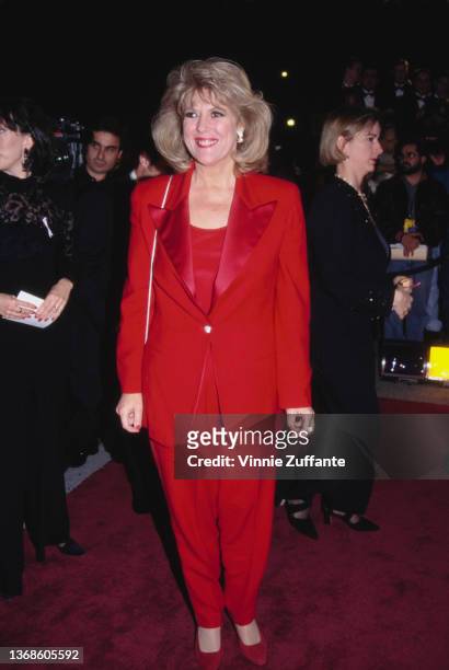 American actress Meredith MacRae , wearing a red trouser suit, attends the 10th Annual American Comedy Awards, held at the Shrine Auditorium in Los...
