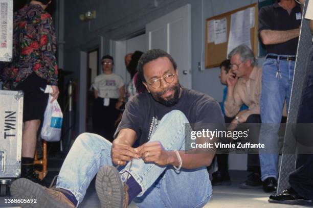 American singer, songwriter and musician Bobby McFerrin tying his shoelaces backstage at the 'Children for the Rainforest,' benefit for the...