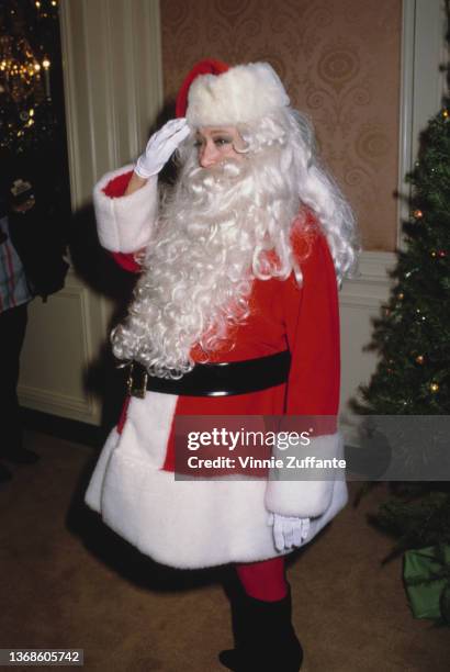 American actress and singer Dorothy Lamour attends an event, dressed in a Father Christmas costume, circa 1985.