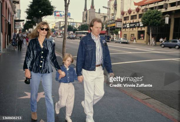 American actor, musician and comedian Michael McKean and his wife, Susan, either side of their son, Fletcher, holding his hands as they attend the...