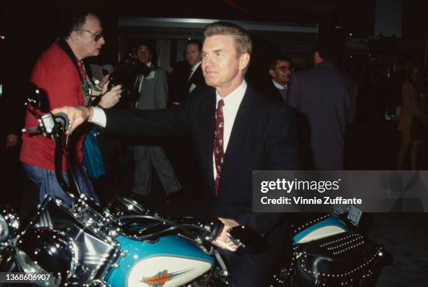American actor Kent McCord sits astride a Harley-Davidson motorcycle as he attends the 32nd Annual National Association of Television Program...