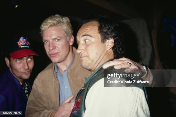 American actor Christopher McDonald, wearing a suede jacket with the 'Planet Hollywood' logo, and American actor and comedian Jim Belushi, wearing a...