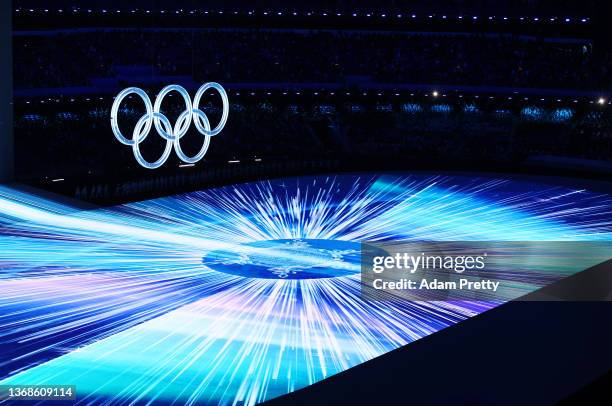 General view inside the stadium as a light show is seen around the Olympic rings during the Opening Ceremony of the Beijing 2022 Winter Olympics at...