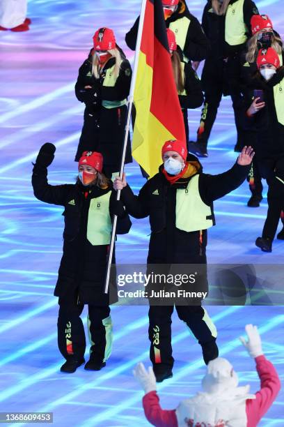 Flag bearers Francesco Friedrich and Claudia Pechstein of Team Germany lead their team out during the Opening Ceremony of the Beijing 2022 Winter...