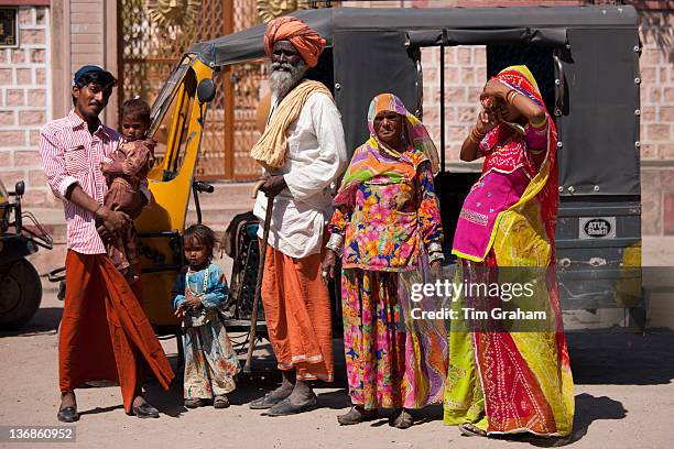 Indian family three generations with pregnant young wife by auto rickshaw in Sadri town in Pali District of Rajasthan, Western India