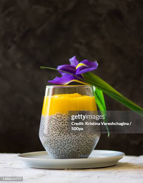 mango chia pudding,close-up of drink in glass on table,omsk,russia - lassi stock pictures, royalty-free photos & images