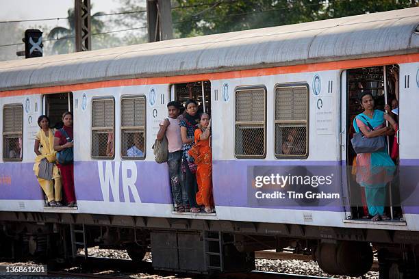 Female workers on crowded commuter train of Western Railway near Mahalaxmi Station on the Mumbai Suburban Railway, India