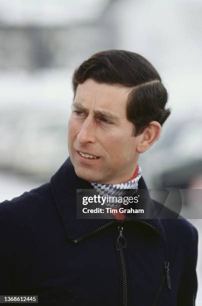 British Royal Charles, Prince of Wales wearing a blue-and-white scarf beneatha dark blue ski jacket during his annual skiing holiday in Klosters,...