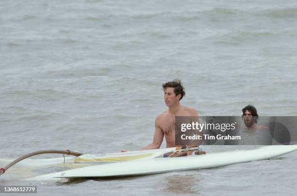 British Royal Charles, Prince of Wales tries his hand at windsurfing in the waters off the beach in Deauville, Normandy, France, 20th August 1978.