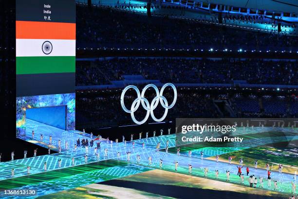 Large Olympic ring logo is seen inside the stadium as flag bearer Arif Mohd Khan of Team India leads their team out during the Opening Ceremony of...