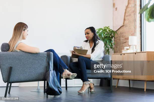 mid adult therapist and female client meet for counseling session - vulnerability stock pictures, royalty-free photos & images