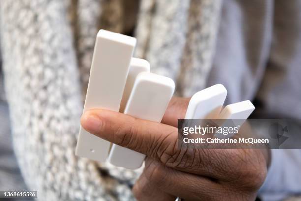 african-american female reads results of five (5) at-home covid-19 tests - delta i stock pictures, royalty-free photos & images