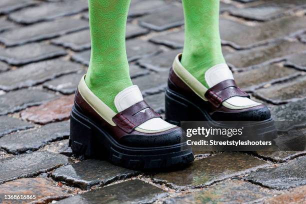 Influencer Emma Fridsell wearing green tights by Ganni and brown-white loafers by Ganni, seen outside the TOMORROW DENIM show during Copenhagen...