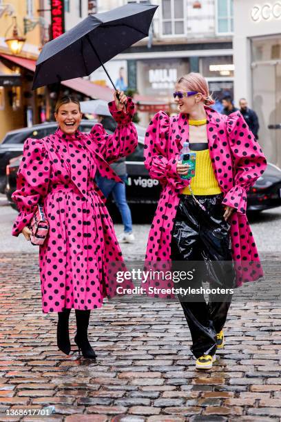 Influencer Janka Polliani wearing a pink coat with black dots by Balenciaga, black boots by by Balenciaga and a rose, black and white bag by Chanel...