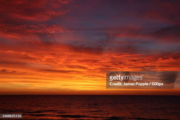 glenelg south,adelaide,scenic view of sea against dramatic sky during sunset,s esplanade,south australia,australia - james popple stock-fotos und bilder