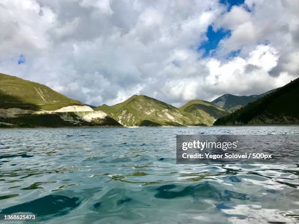 lake kezenoyam,chechen republic,scenic view of lake by mountains against sky,vedenskiy rayon,russia - solovei stock pictures, royalty-free photos & images