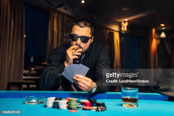 poker player smoking a cigar - holding sunglasses stock pictures, royalty-free photos & images