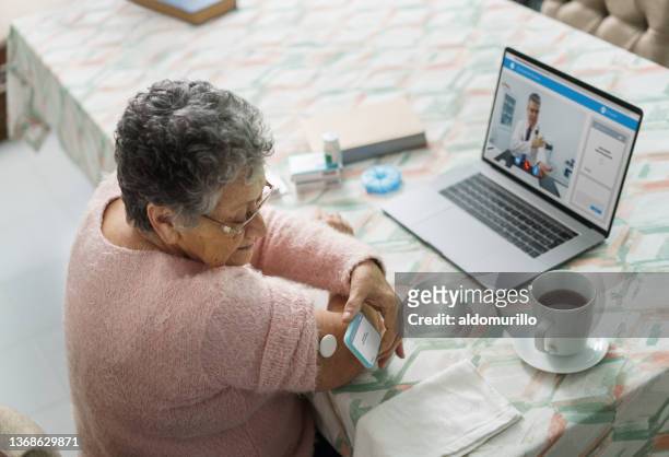 Senior woman using health technology at home during teleconsultation