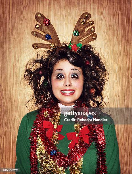 young woman wearing reindeer antlers - uncool fotografías e imágenes de stock