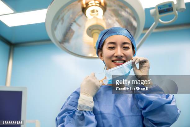 young asian female doctors in the operating room. - surgeon patient stock pictures, royalty-free photos & images
