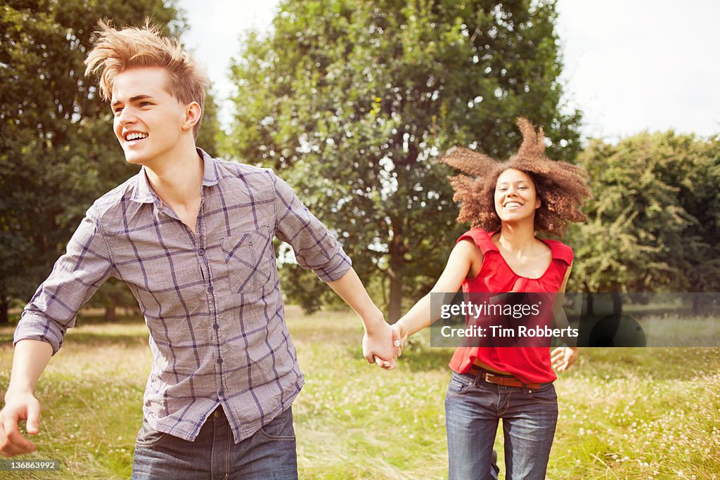 Young couple running in countryside.