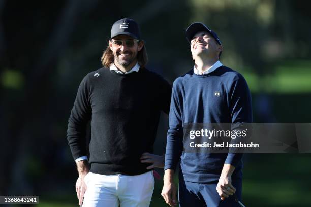 Jordan Spieth of the United States talks to musician Jake Owen on the 11th green during the second round of the AT&T Pebble Beach Pro-Am at Spyglass...