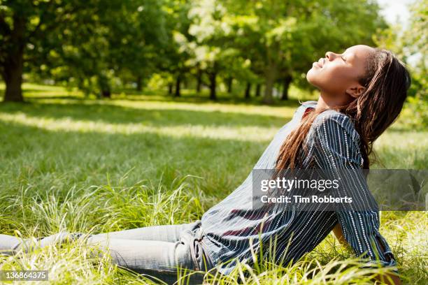 young woman soaking up the sun. - sunbathing stock pictures, royalty-free photos & images