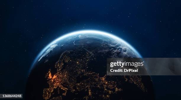 planet earth seen from space. night in europe and asia with city lights - earth atmosphere stock pictures, royalty-free photos & images