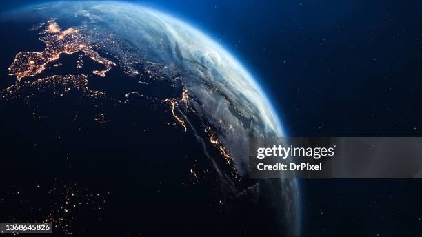 planet earth seen from space. night in europe with city lights - asia continent stockfoto's en -beelden