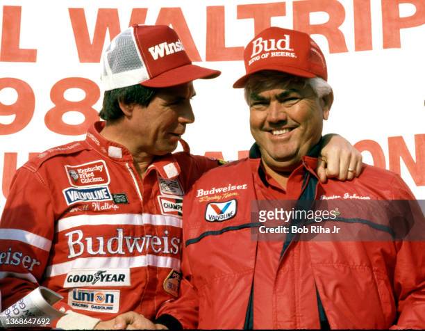 Racer Darrell Waltrip celebrates his 7th place finish in the Winston Western 500 at Riverside Speedway with Junior Johnson as he clinched his third...