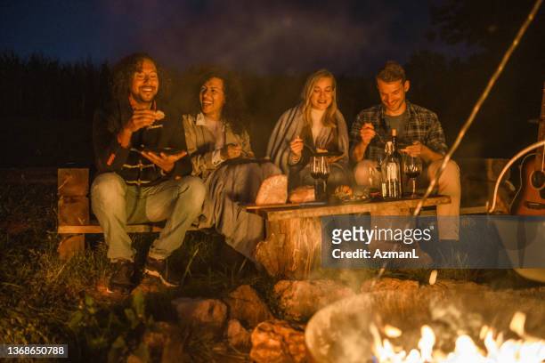 Mixed Race Friends Camping Together In Nature