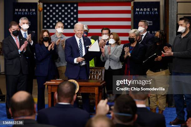 President Joe Biden holds up an executive order about project labor agreements he just signed with Vice President Kamala Harris, Labor Secretary...