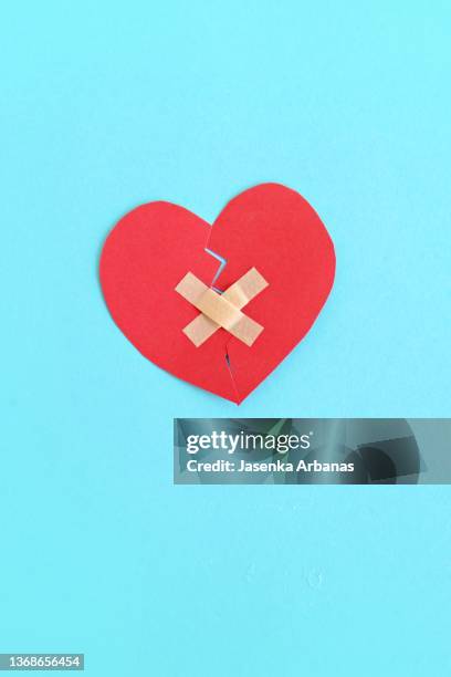 broken heart with bandage - broken heart stockfoto's en -beelden